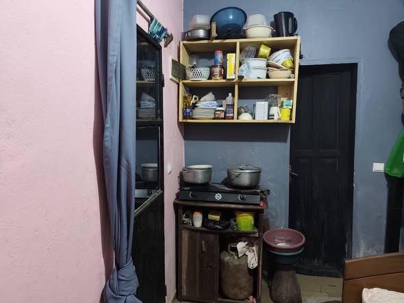 Room with TV and kitchen setup