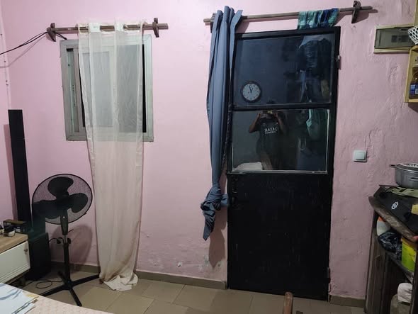 Room with TV and kitchen setup