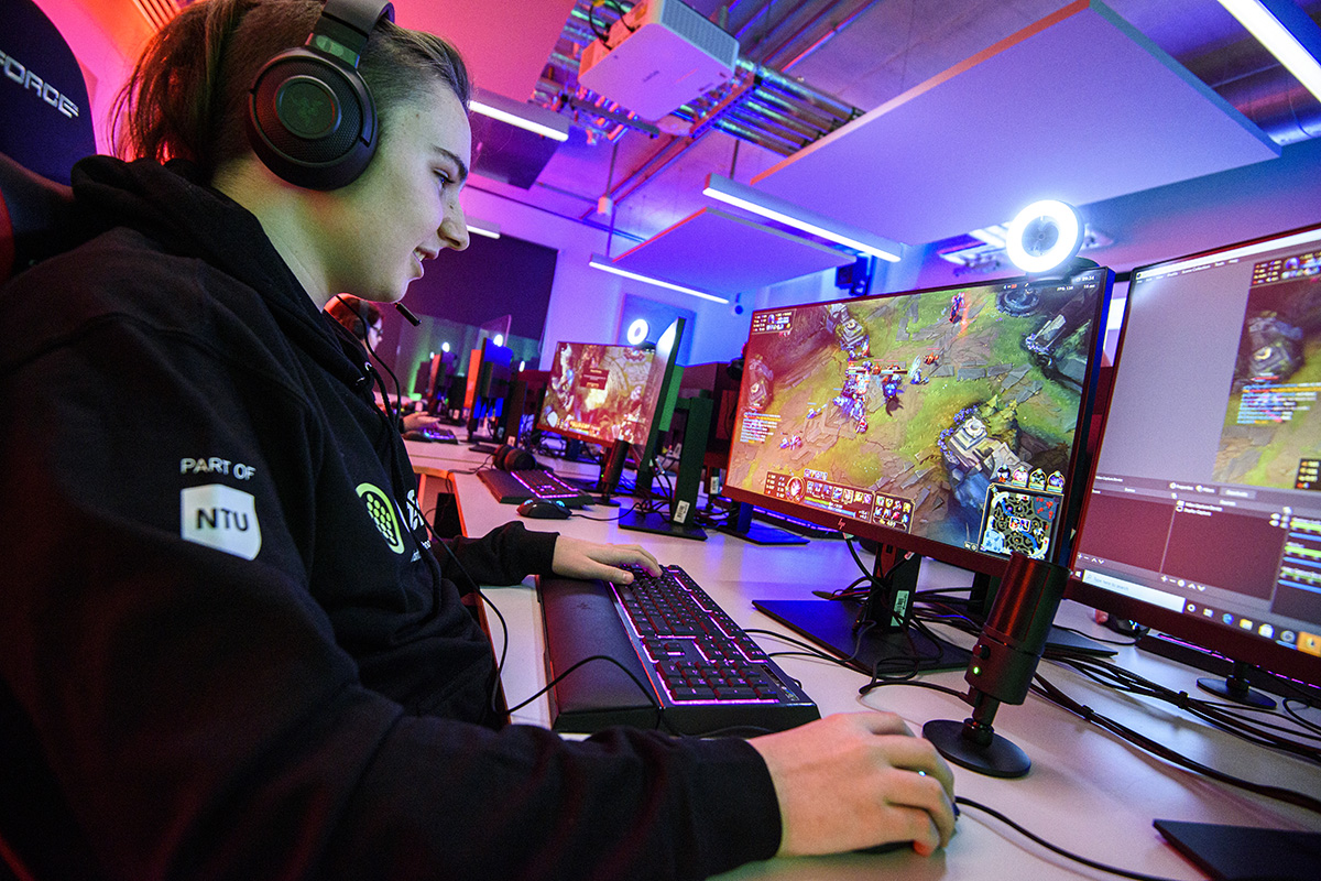 An esports degree student sat a desk and computer