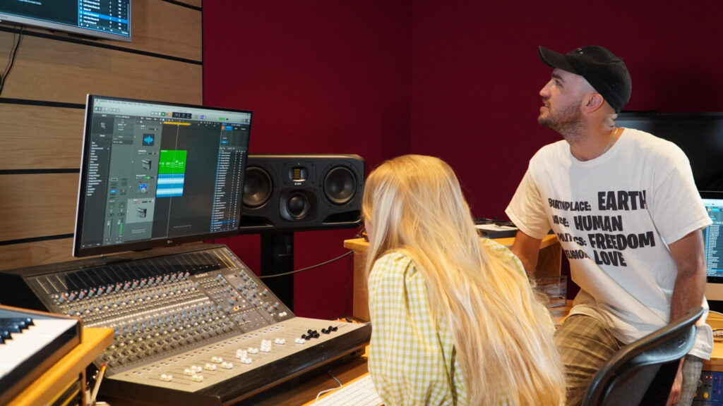 Students song writing and producing together in a studio at Tileyard