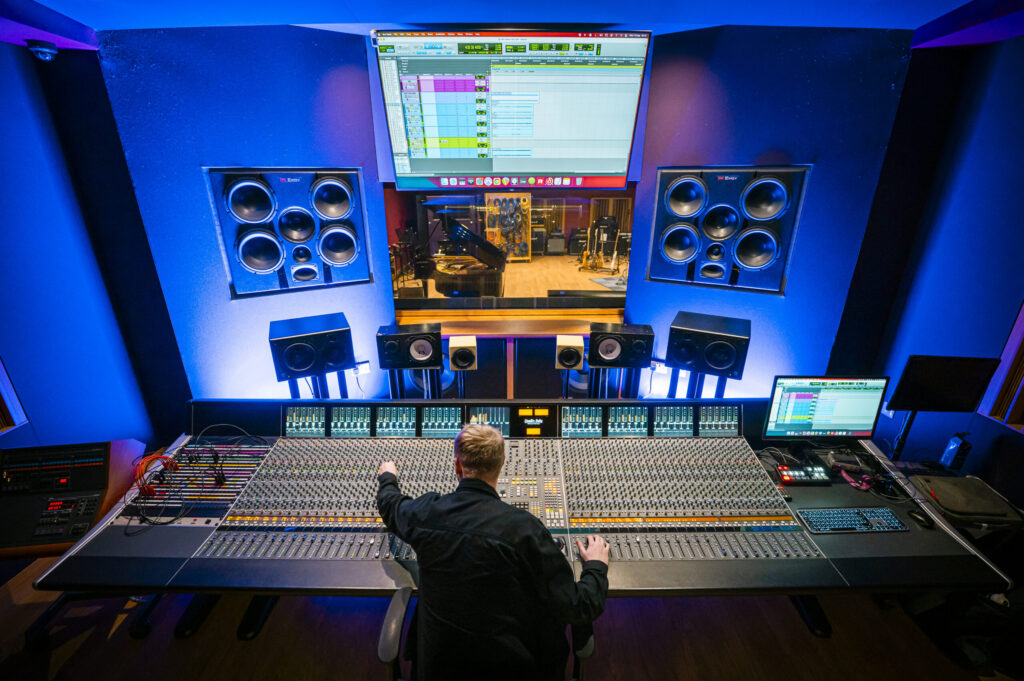 Student producing music in a music studio