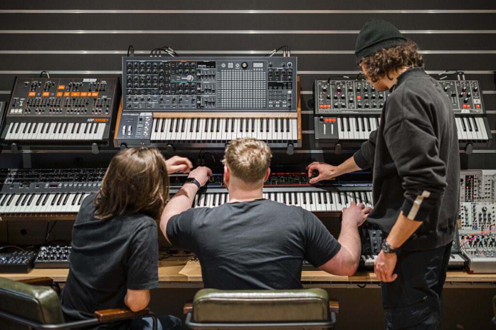 Students using synth equipment