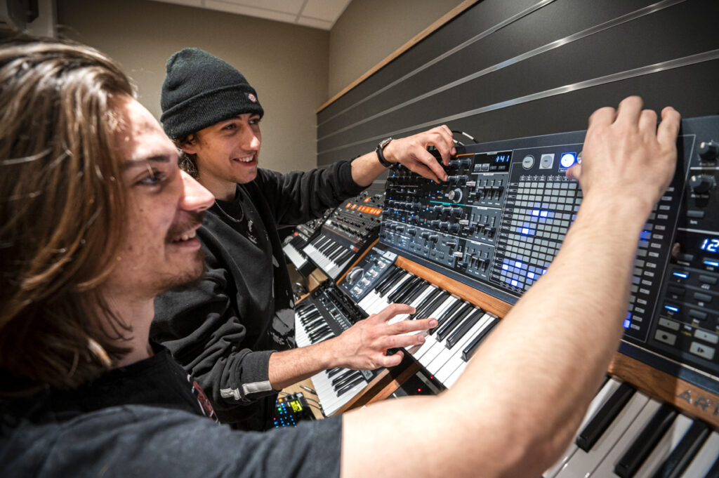 Students using synth equipment