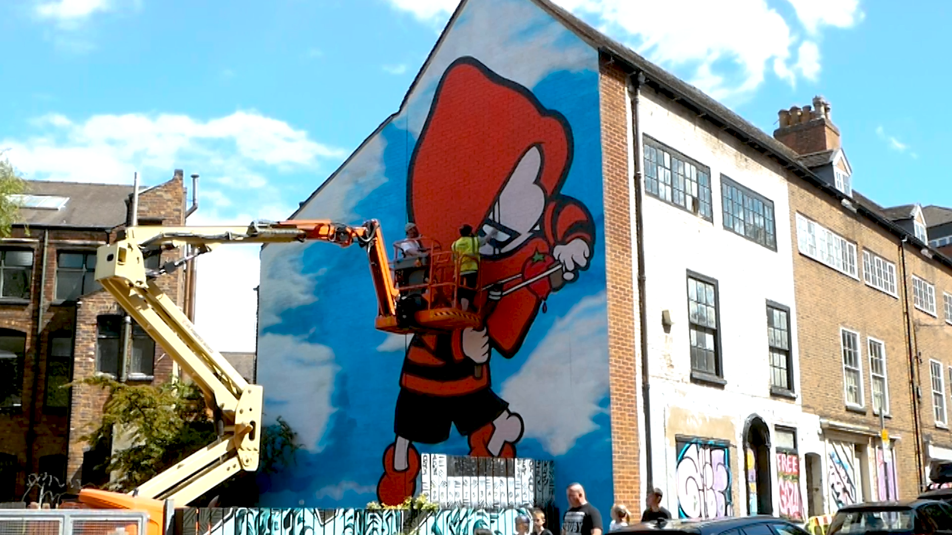 A street artist spray creating art in Nottingham city centre