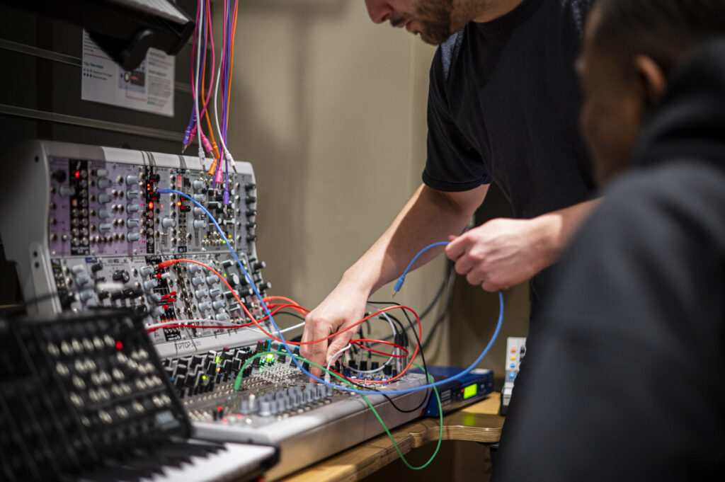 Student using synth equipment