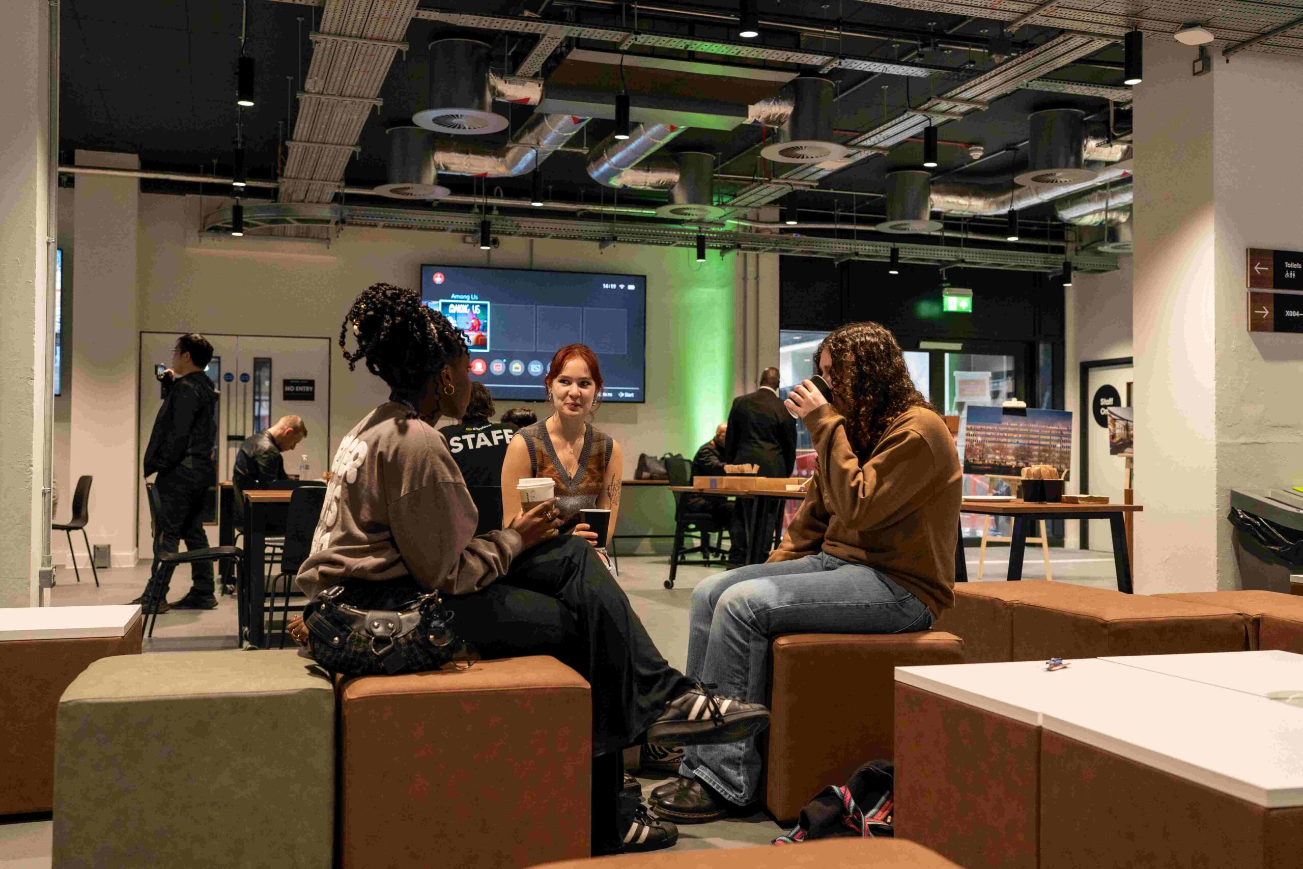 Students sat in the social space on the London campus