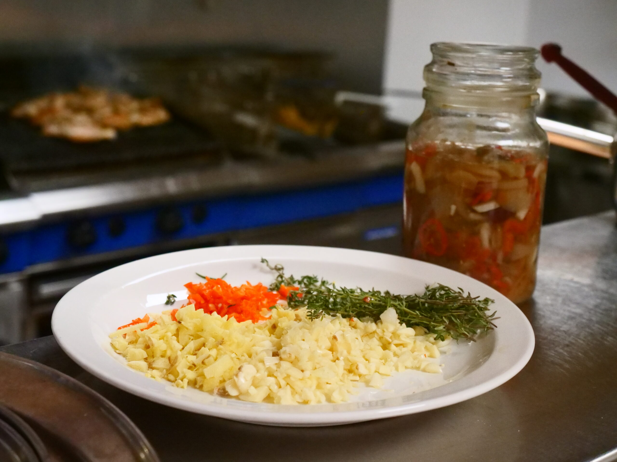 Plate of food with jar of relish next to it