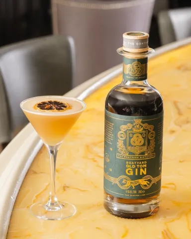 Bottle of Boatyard Old Tom Gin with a cocktail