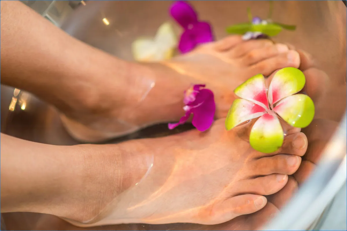 Feet in water with floating flowers