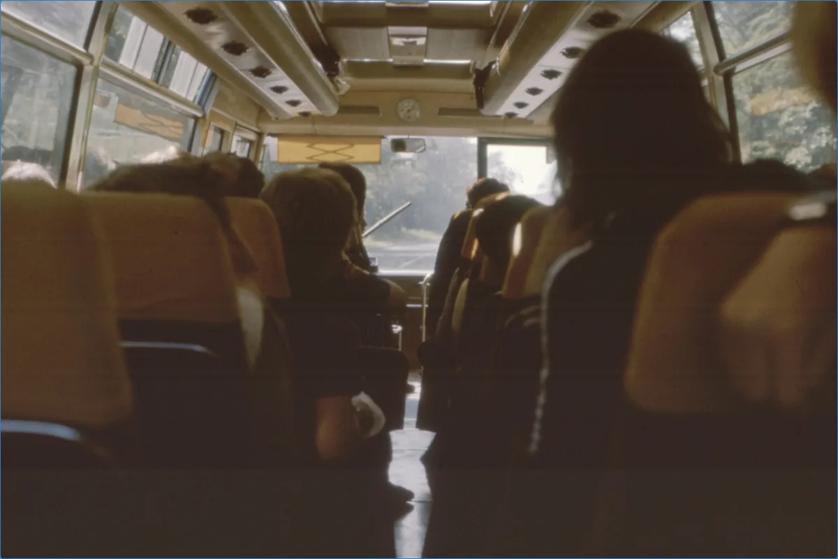 Interior of a bus with passengers seated.
