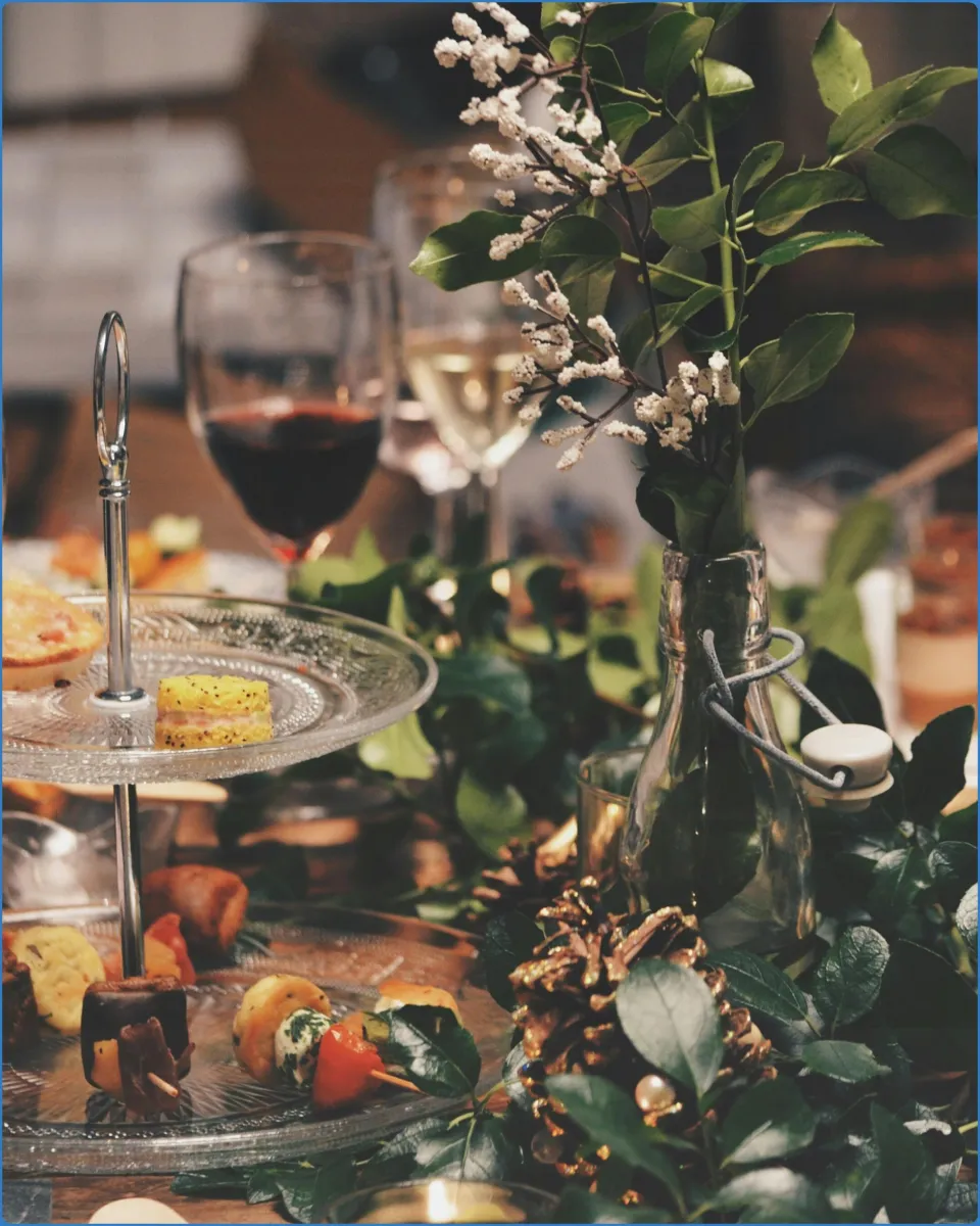 Elegant table setting with wine glasses and appetizers.