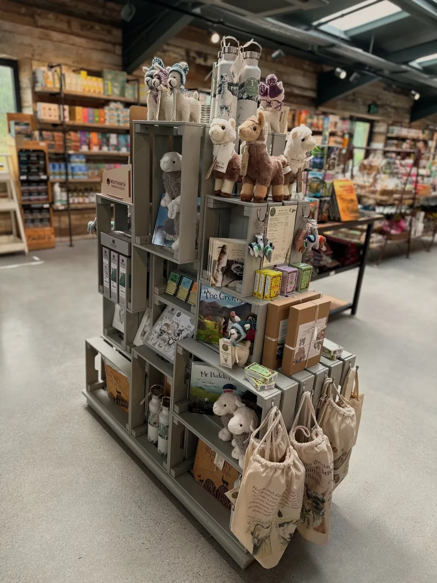Alpaca-themed toys and souvenirs displayed in the Alpacaly Ever After gift shop