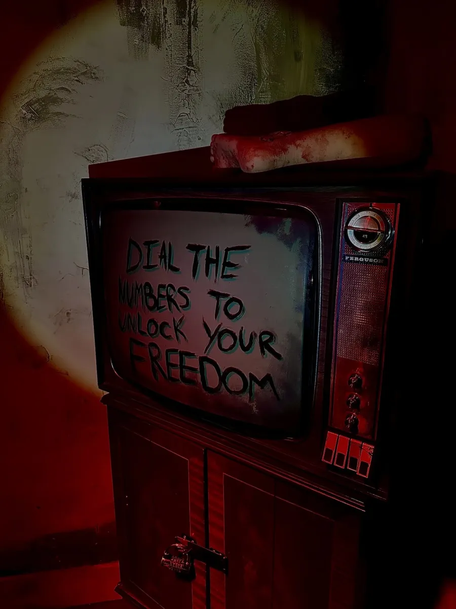 Old TV with message 'Dial the numbers to unlock your freedom'.