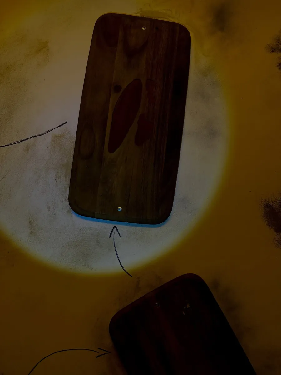 Wooden boards with arrows on a yellow surface.