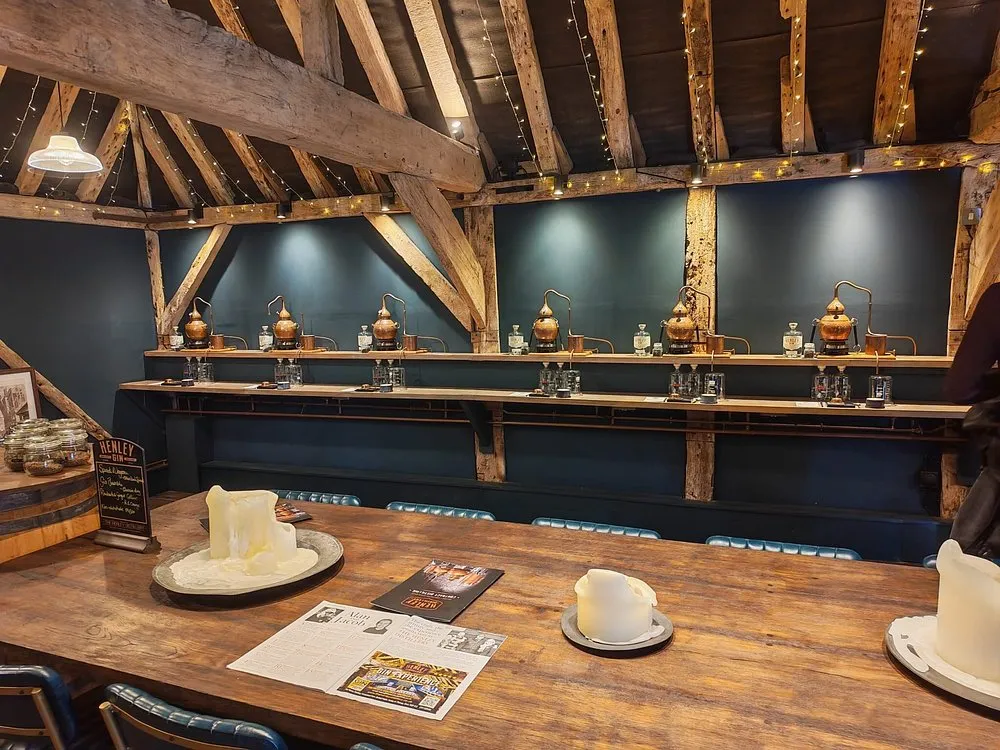 Interior of a distillery with copper stills and wooden beams.