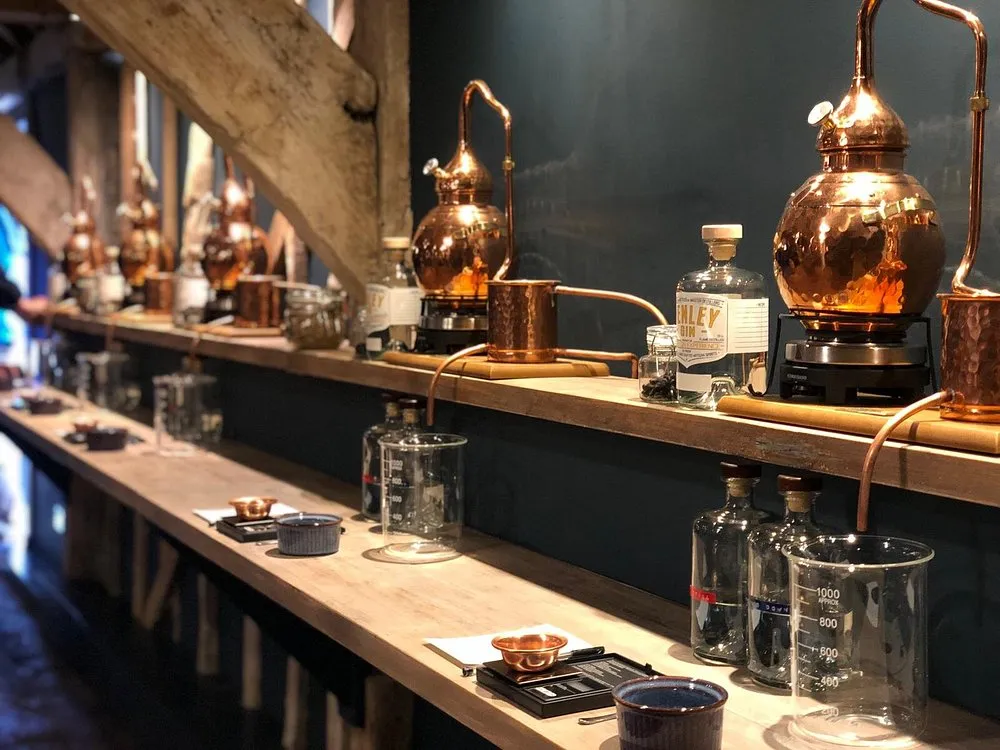 Copper distillation equipment on a wooden shelf.