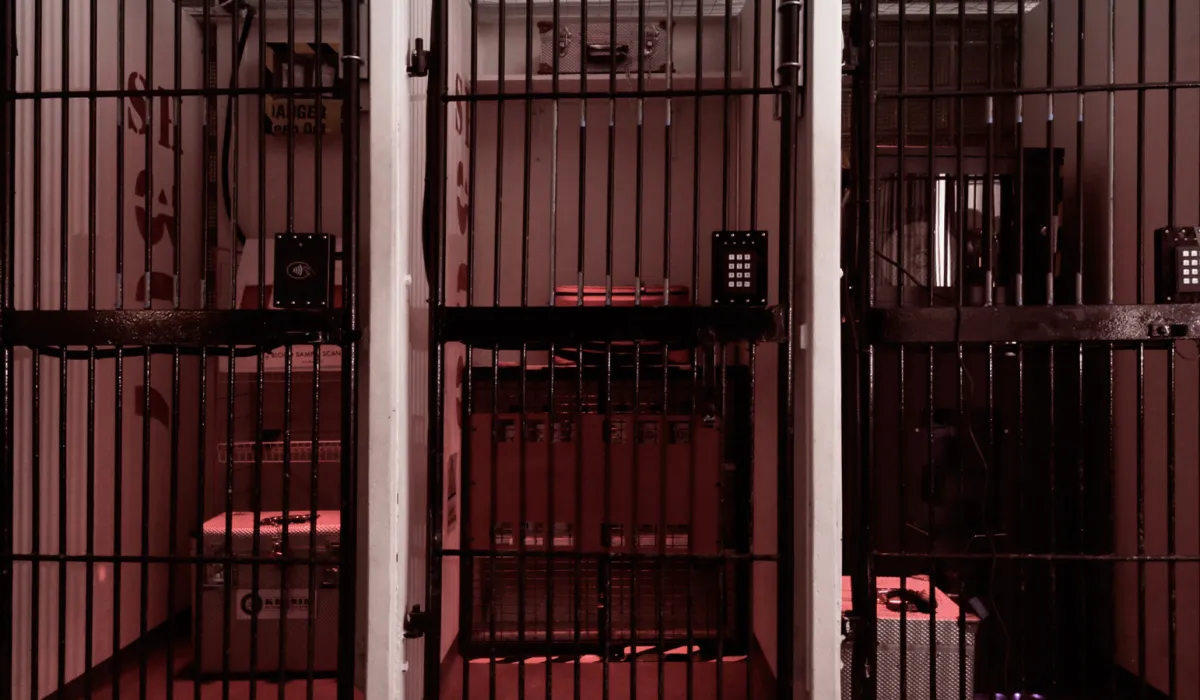 Secure storage area with metal bars and keypad locks.