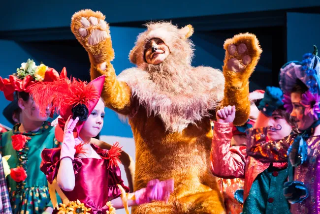 Children in colorful costumes on stage