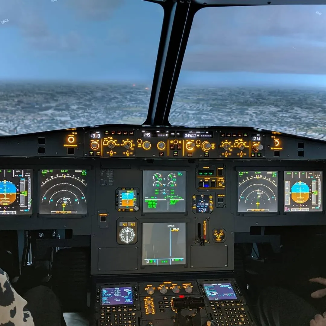 Airplane cockpit with illuminated control panels.
