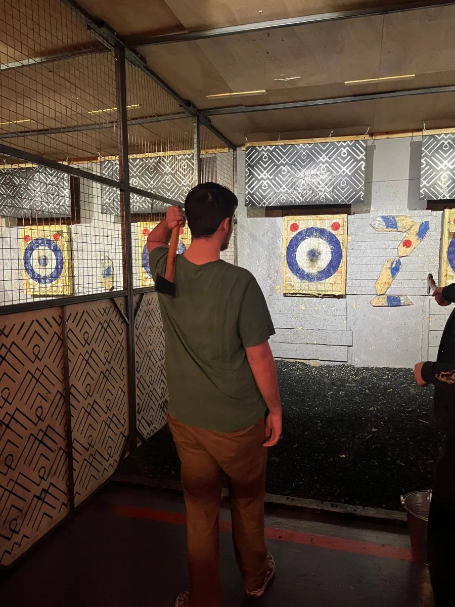 Person preparing to throw an axe at a target.