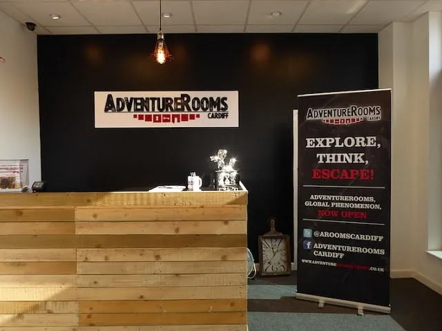 Adventure Rooms Cardiff reception area with sign and banner.