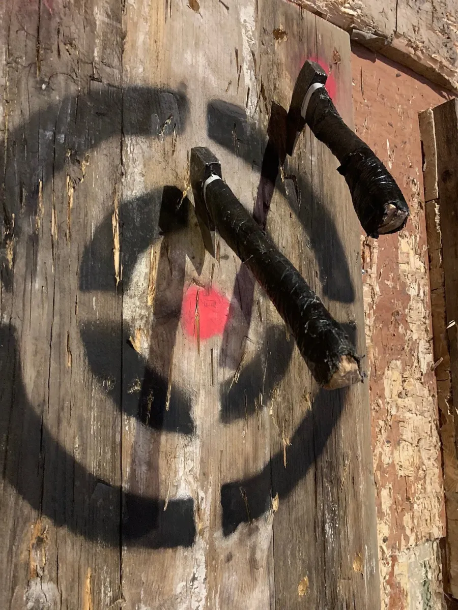 Two axes stuck in a wooden target.