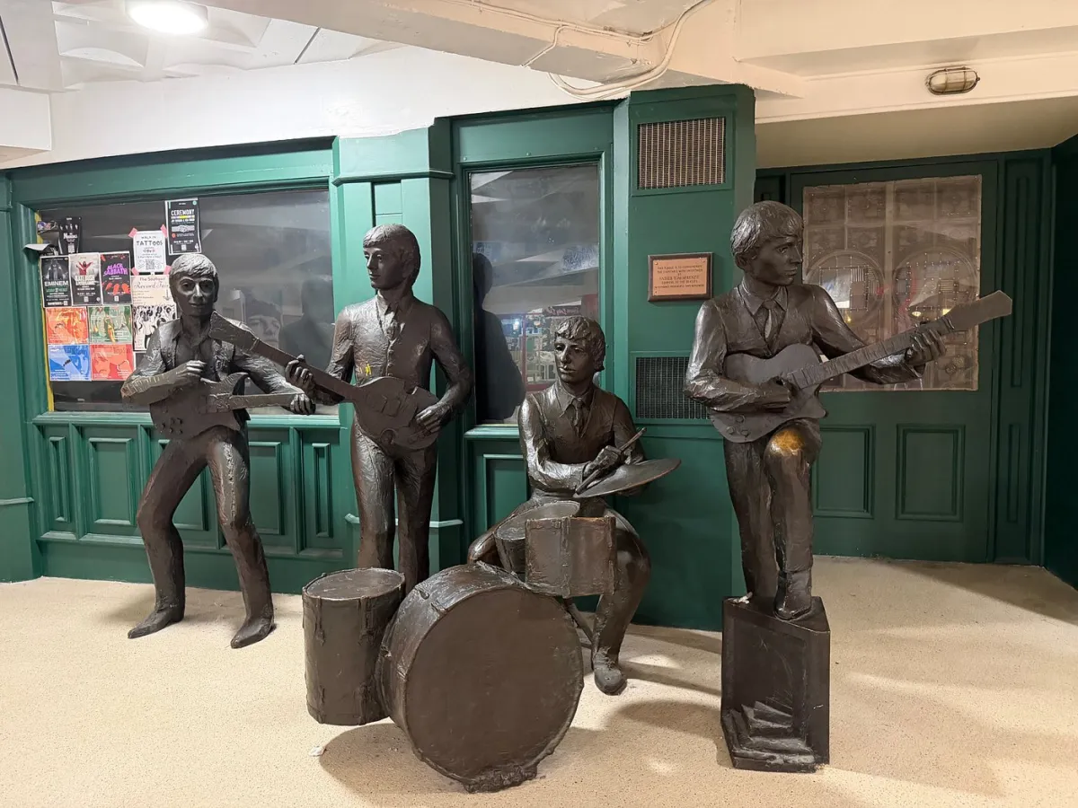 Statues of a band with guitars and drums.
