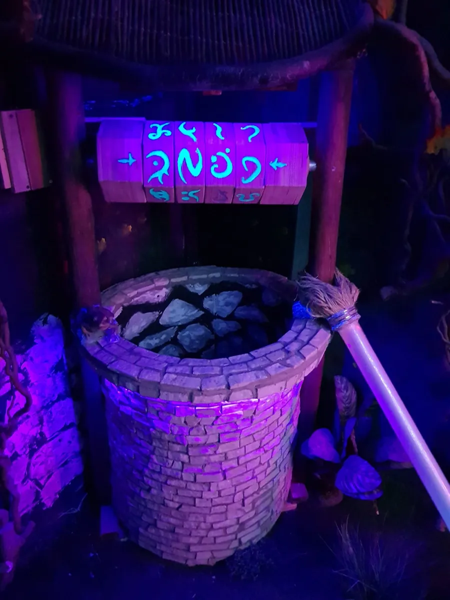 Stone well with glowing symbols in dim lighting