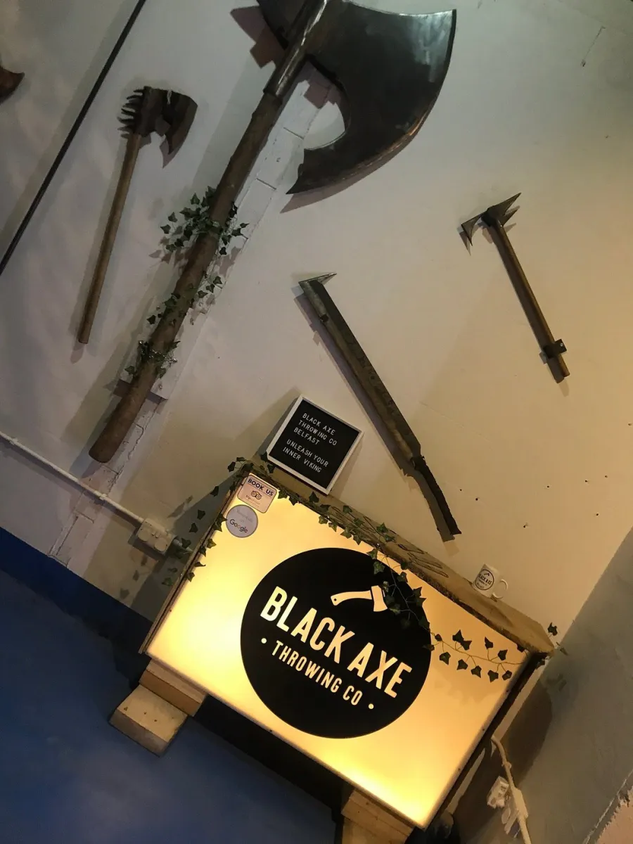 Axe throwing venue with decorative axes on the wall.