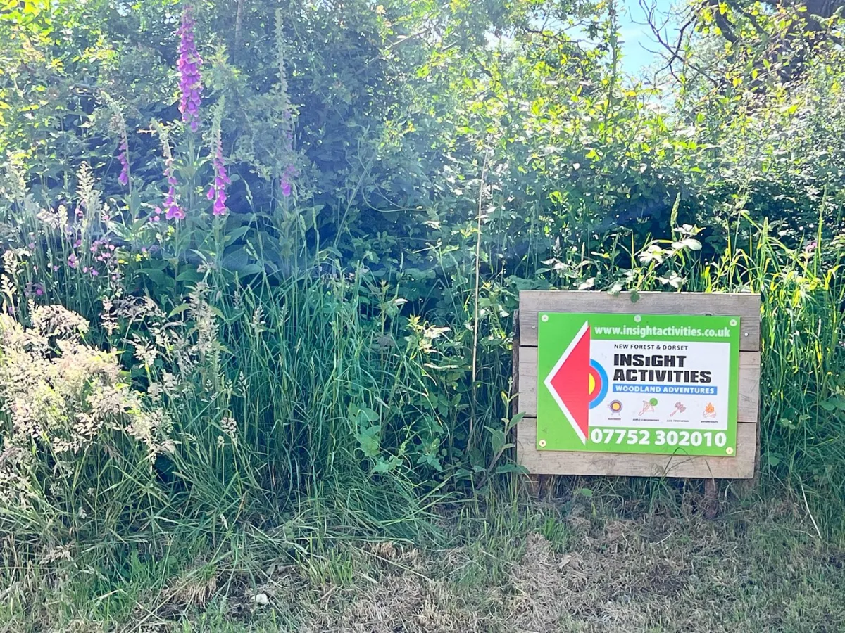 Sign for Insight Activities in a grassy area.