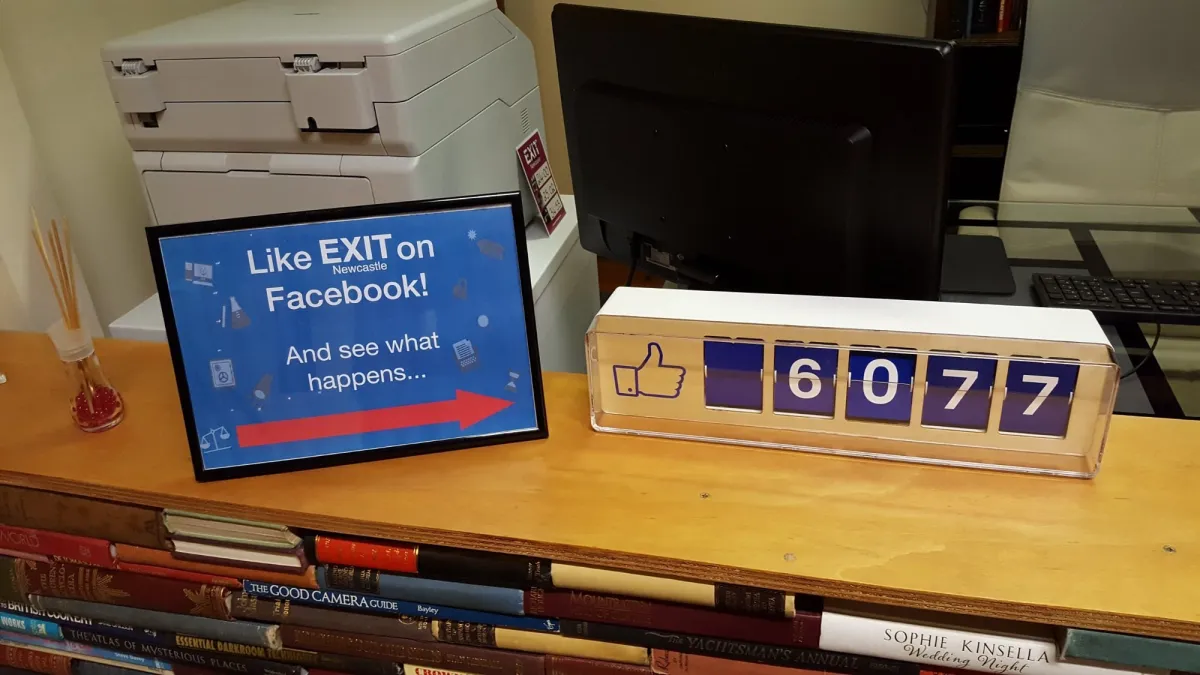 Desk with Facebook like counter and sign.