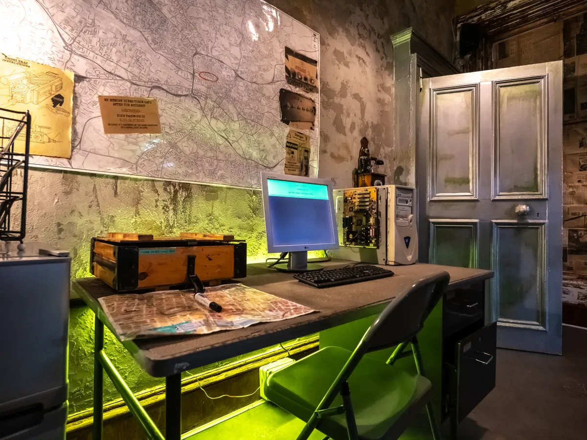 Vintage office with computer and map on wall.