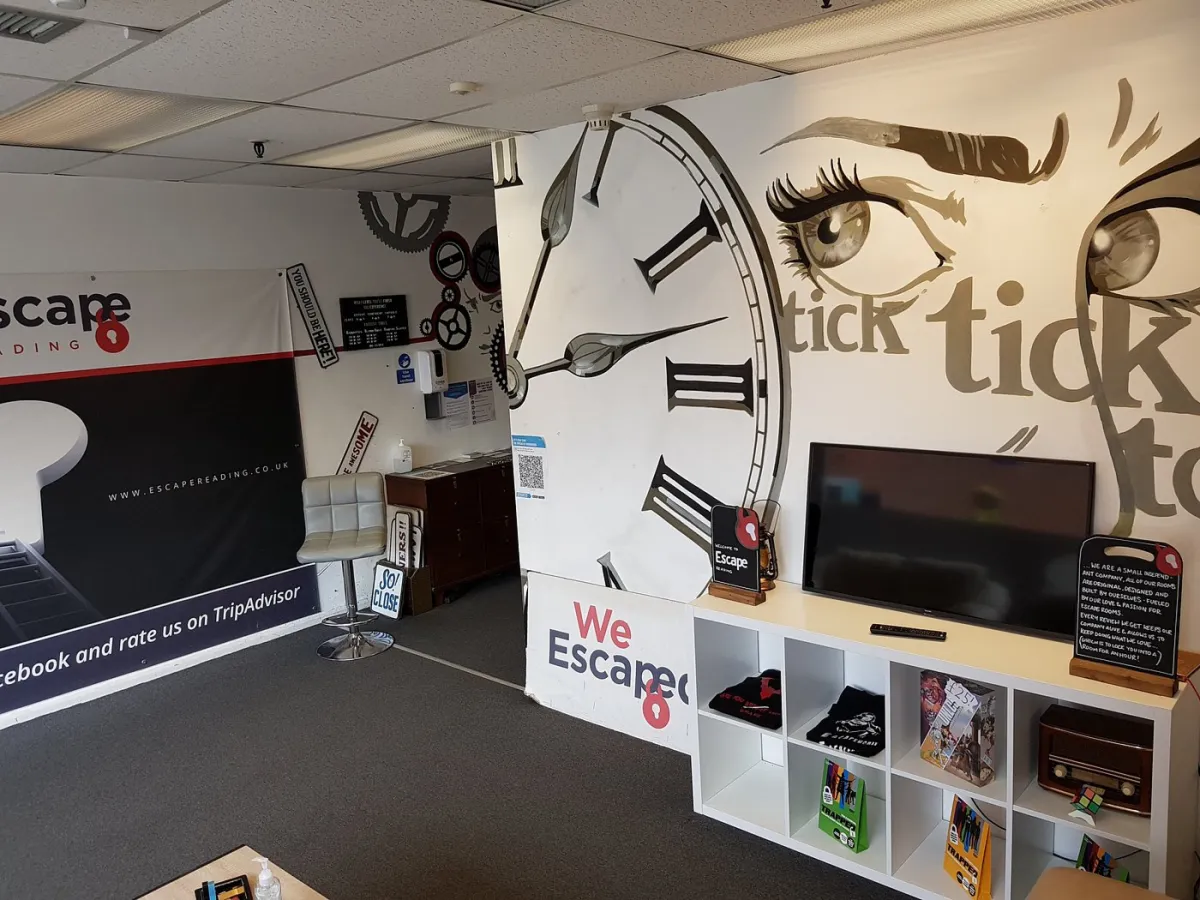 Escape room lobby with clock mural and seating.