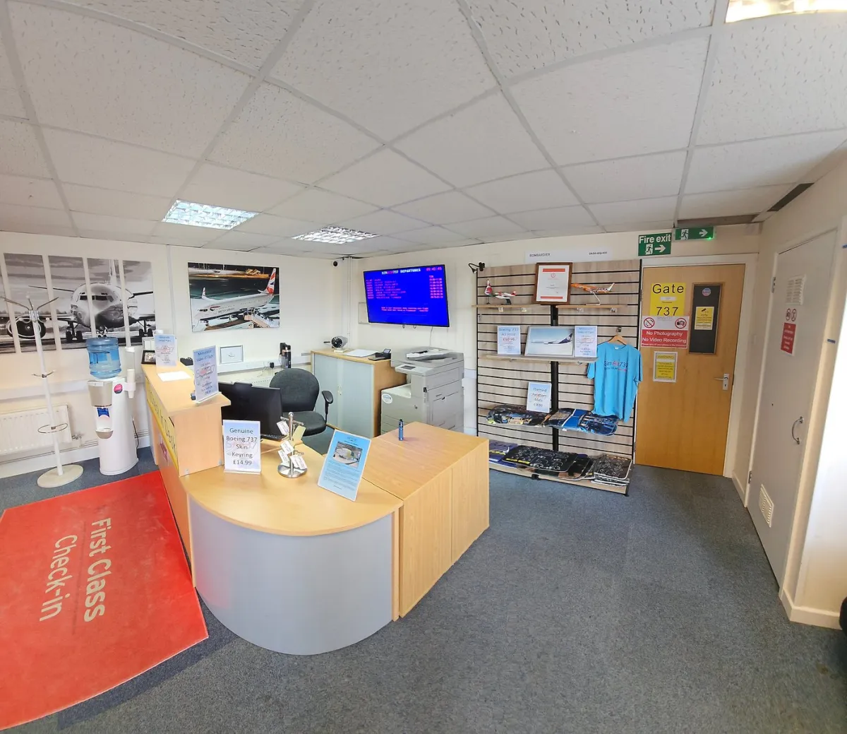 Airport-themed office reception with check-in desk.