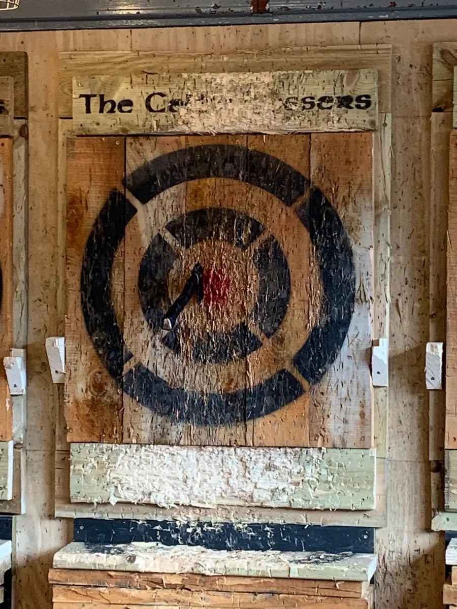 Axe embedded in a wooden target