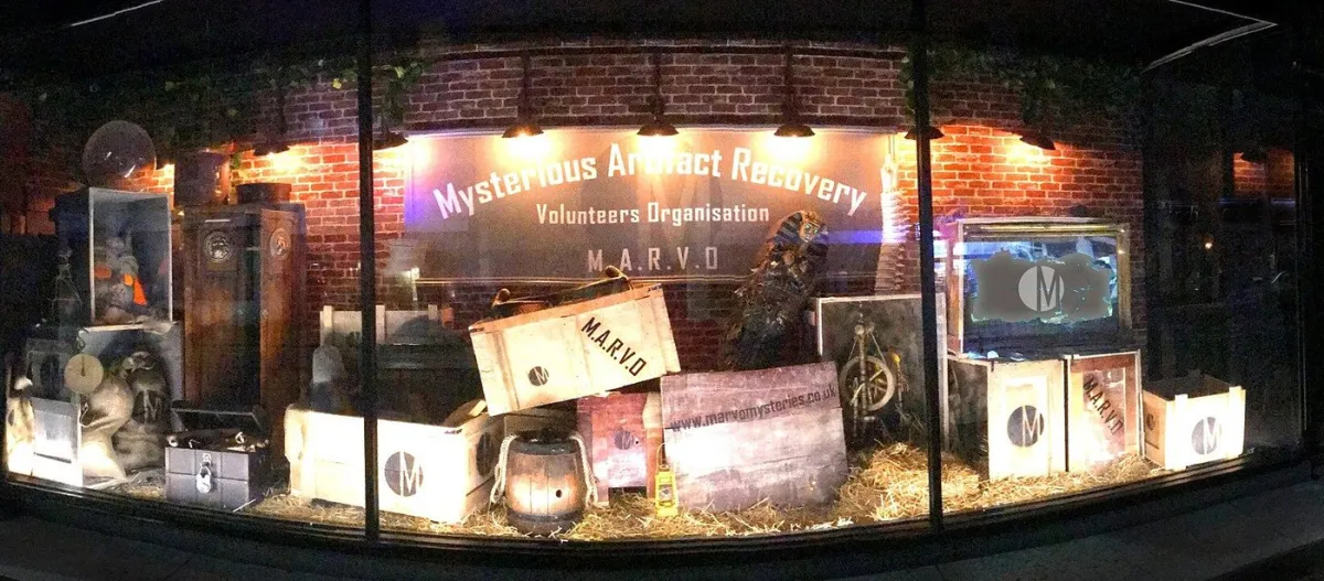 Storefront display with mysterious artifacts and crates.