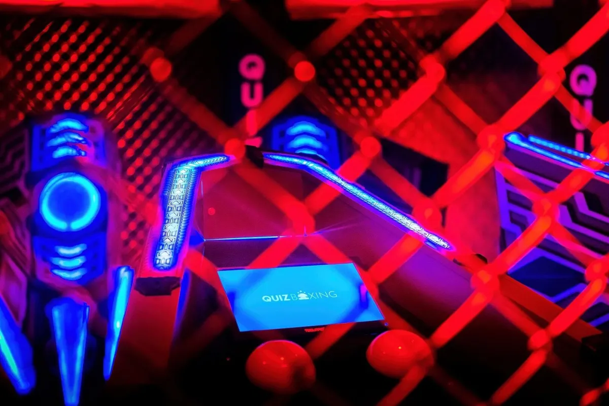 Neon-lit gaming setup with Quiz Boxing display