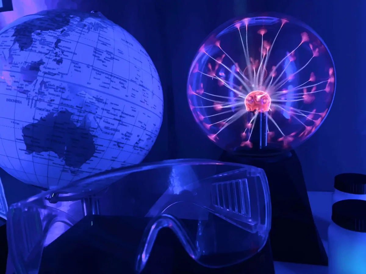 Globe, plasma ball, and safety goggles in blue light