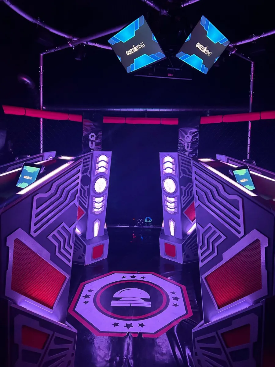 Futuristic gaming arena with neon lights and screens.