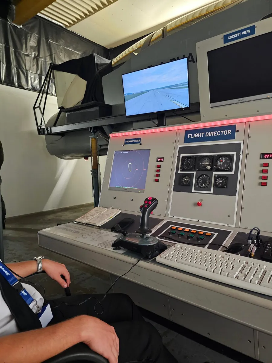 Person operating a flight simulator control panel.