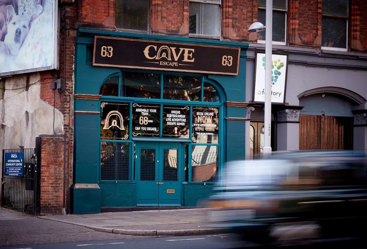 Front of an escape room venue with a moving car.