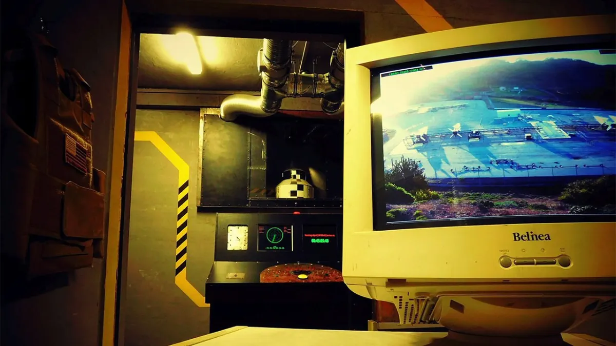 Control room with monitor showing outdoor area.