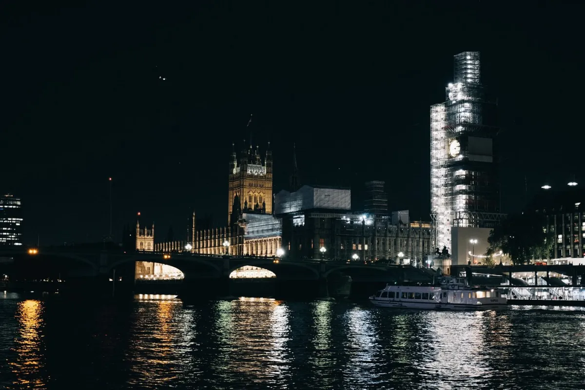 Night view of illuminated buildings by a river