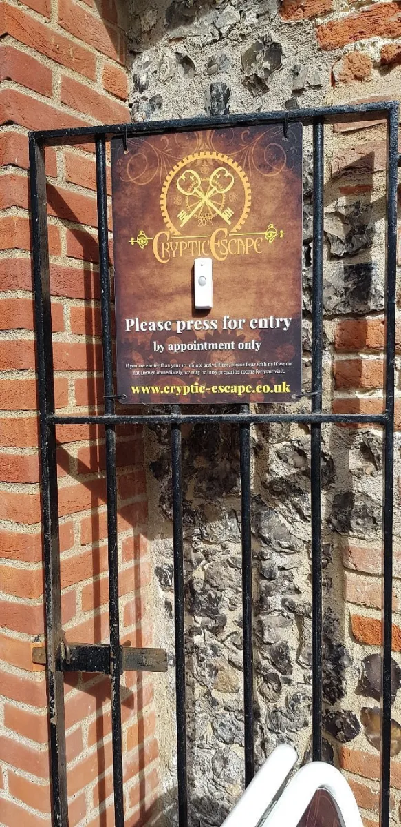 Sign on gate for Cryptic Escape entry by appointment