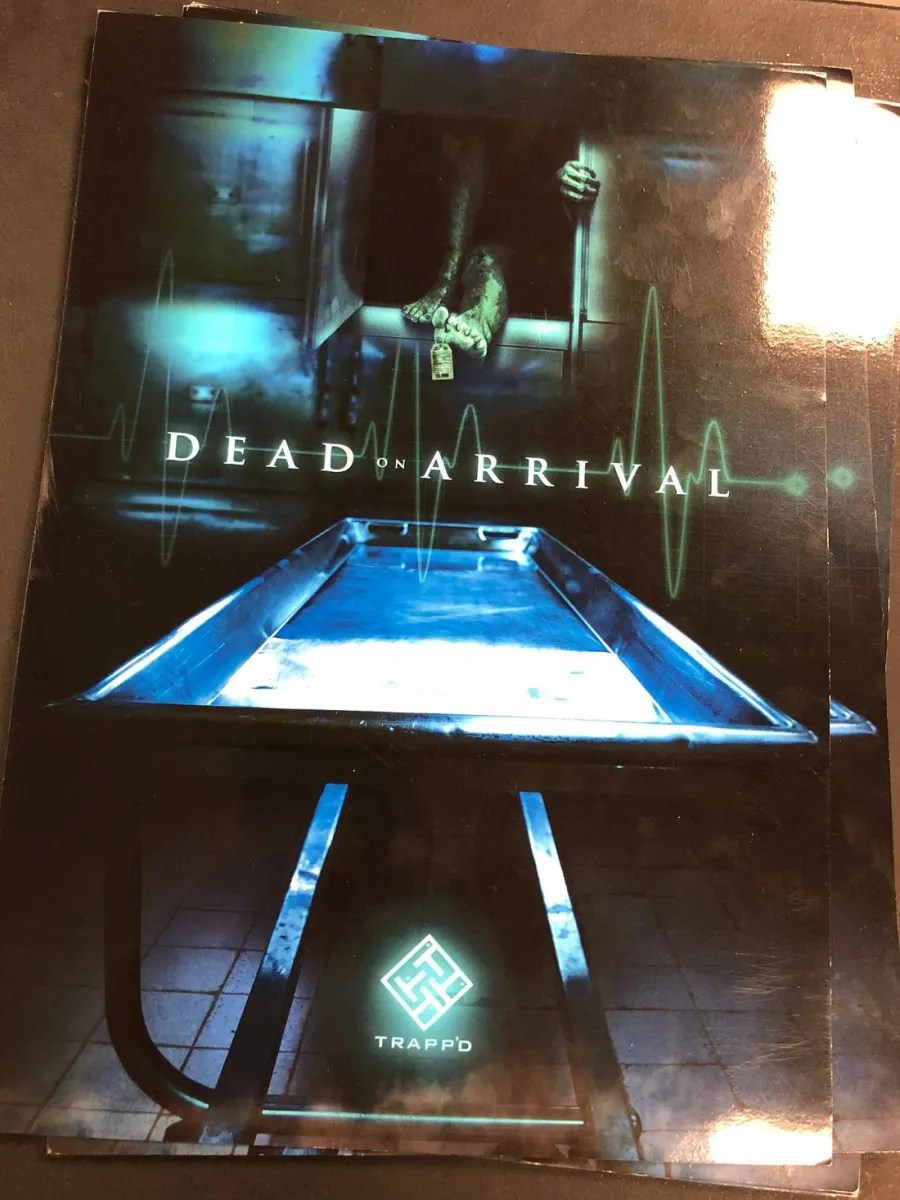Morgue scene with feet and a body tag, text reads 'Dead on Arrival'.