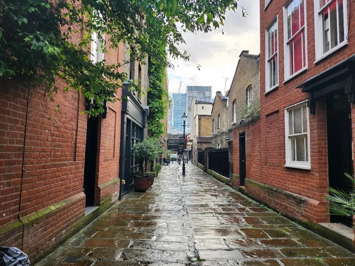 Narrow cobblestone alley with brick buildings