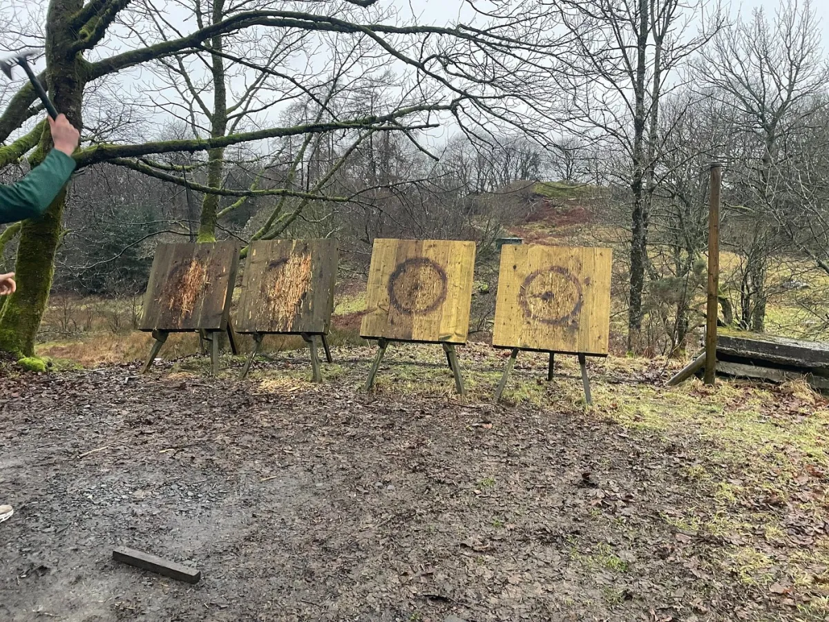 Outdoor axe throwing targets in a forest setting.