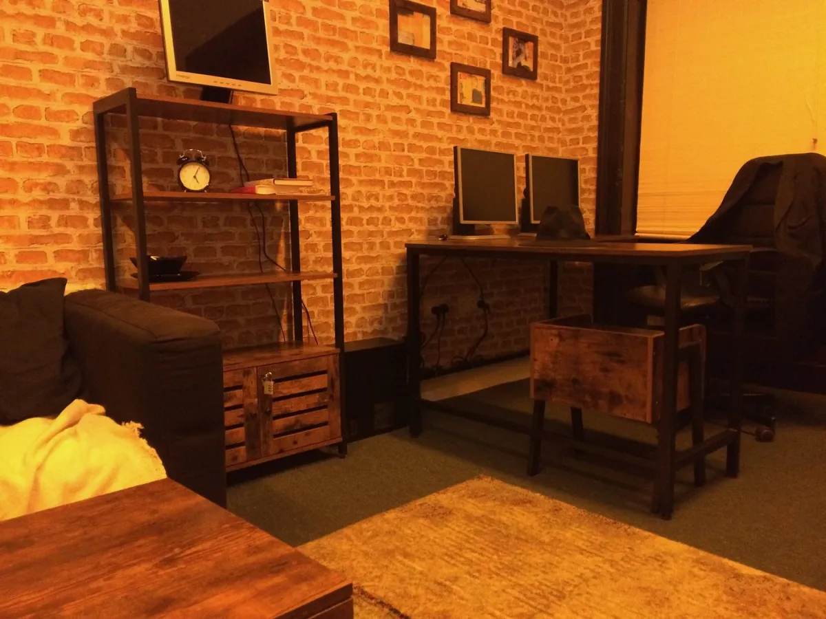 Cozy office with desk, chair, and shelves.