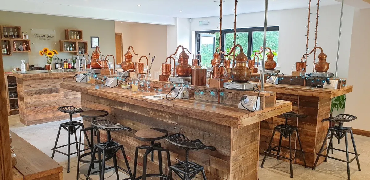 Rustic distillery bar with copper stills and stools