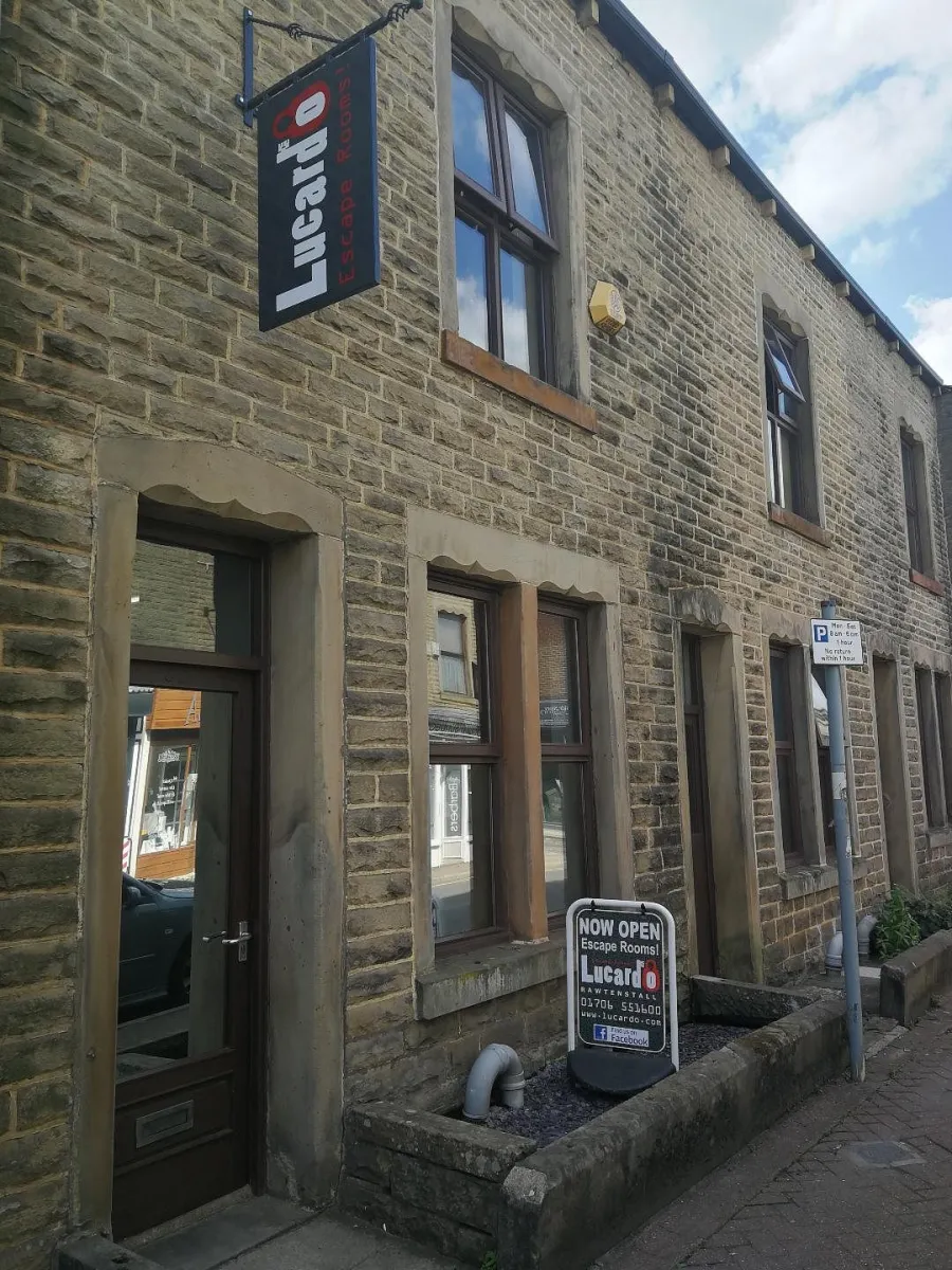 Stone building with Lucardo Escape Rooms sign.